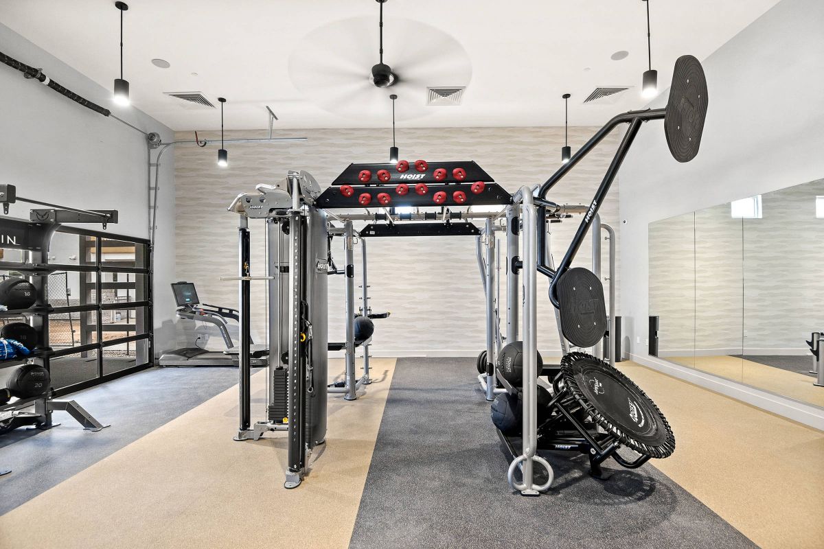 Origin Goodyear fitness center with exercise machines, weights, and a mirrored wall.