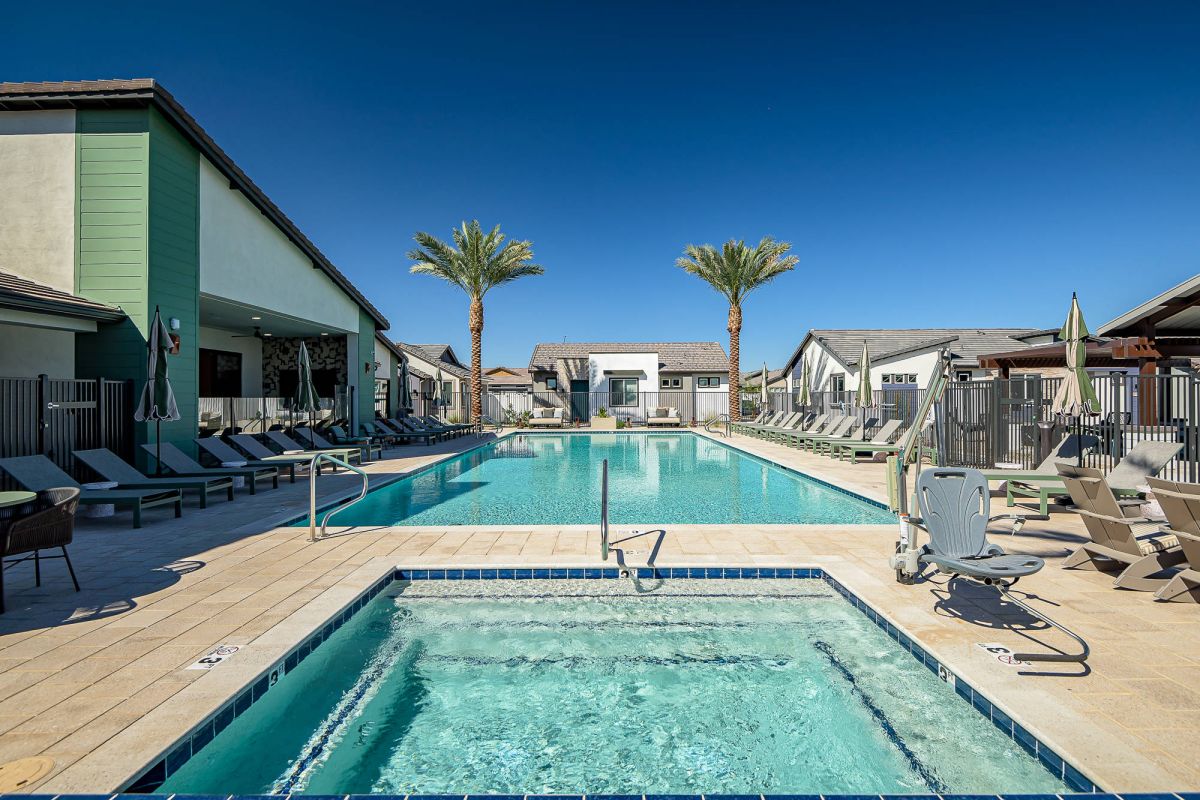 Sonita Goodyear swimming pool with lounge chairs, palm trees, and a hot tub.