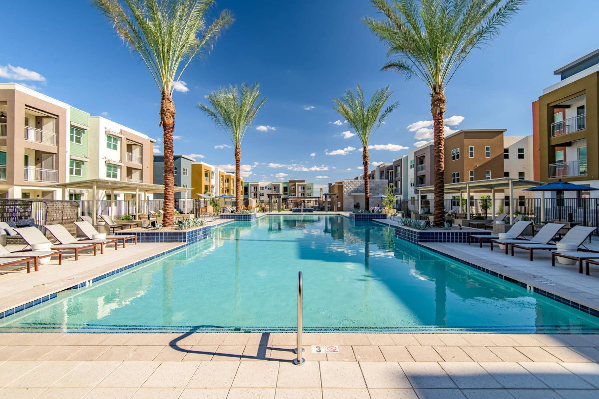 One of two swimming pools at Origin Goodyear with surrounding lounge seating.